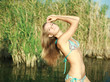 © okostia - Close-up attractive girl in bikini pose in the water