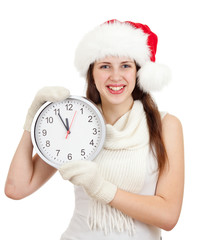 Cute girl in Christmas red santa hat with clock over a white bac