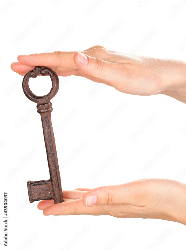woman's hand holding an antique key on white background