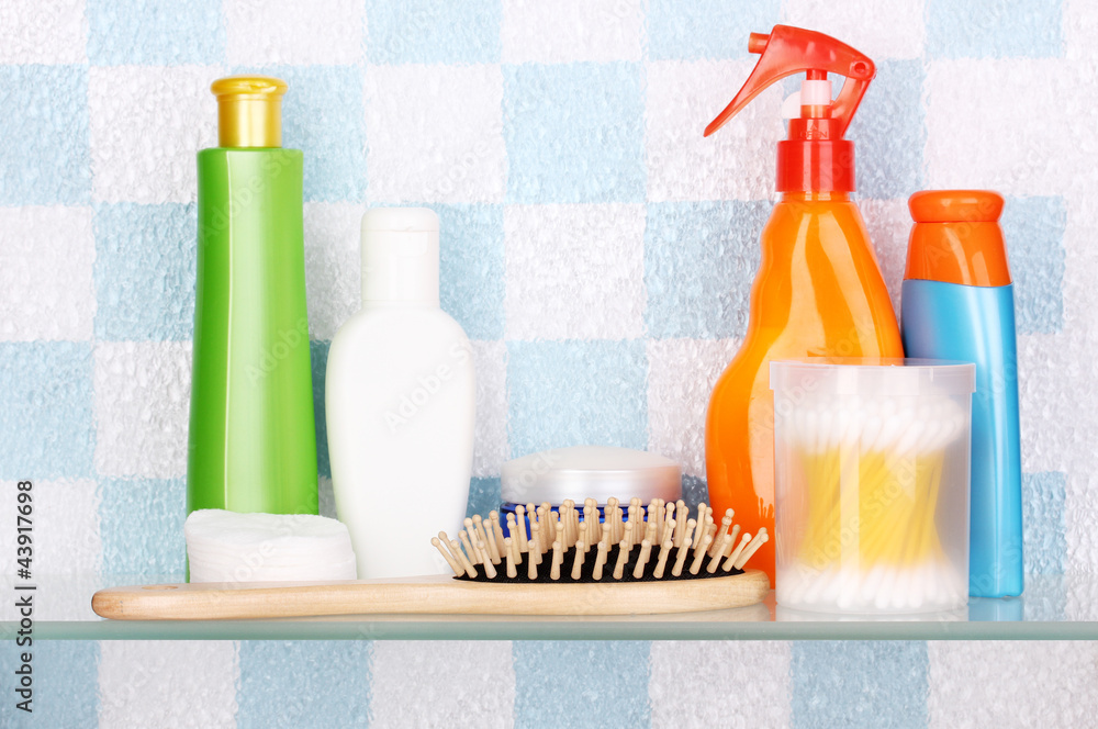 Shelf with cosmetics and toiletries in bathroom