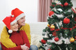 © Alliance - Young couple looking on Christmas tree