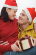 © Alliance - Romantic young couple with Christmas present box