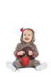 © Alliance - Smiling baby with Christmas ball looking up on copy space