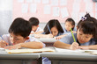 © Monkey Business - Group Of Students Working At Desks In Chinese School Classroom