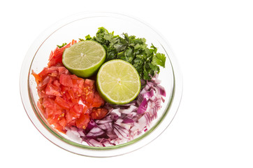 Ingredients for fresh salsa in clear bowl