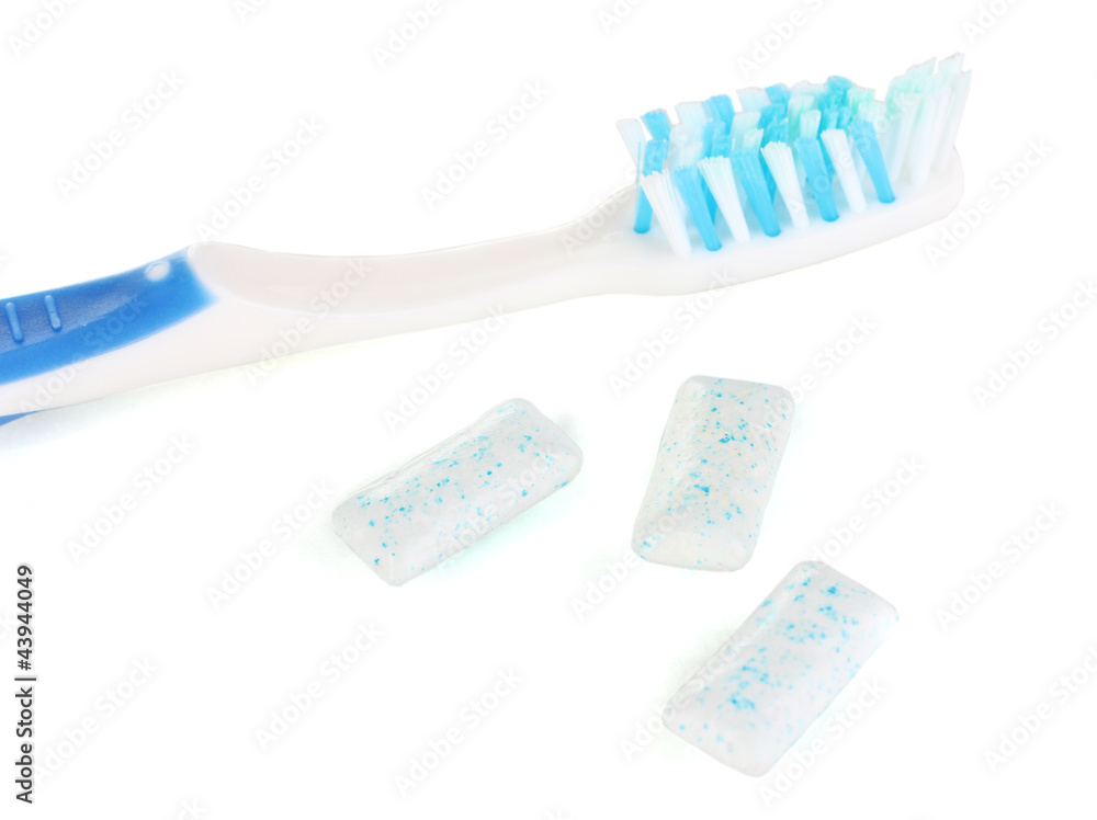Chewing gum and toothbrush isolated on white