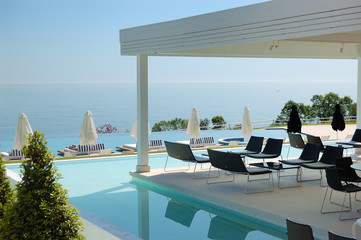 Swimming pool and outdoor restaurant at the modern luxury hotel,