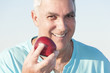 Mature man holding an apple