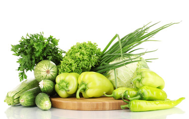 Wall Mural - fresh green vegetables on chopping board isolated on white