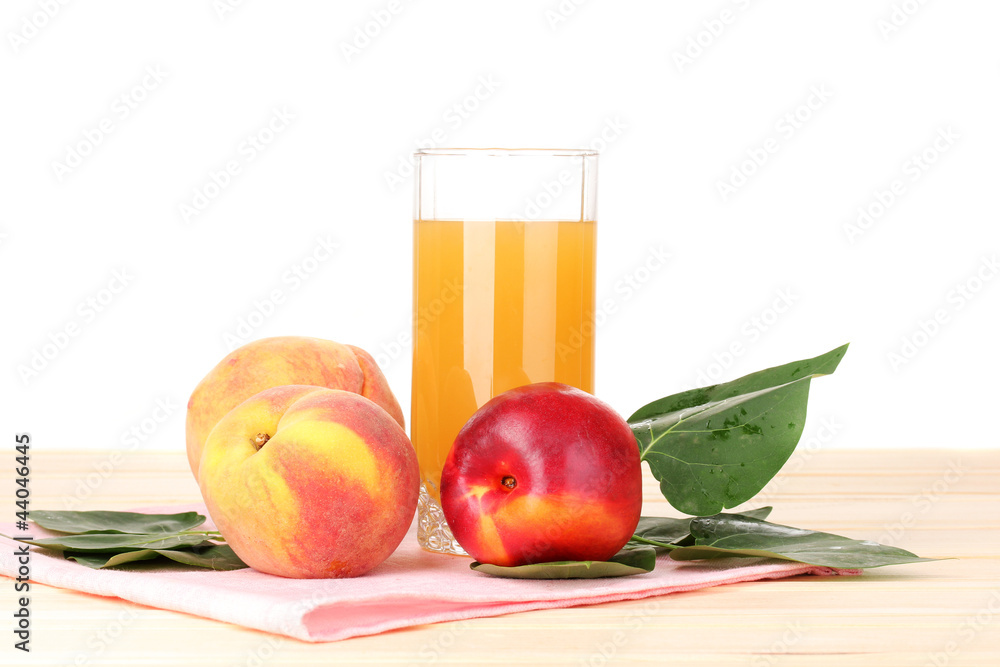 Ripe peaches and juice on wooden table on white background