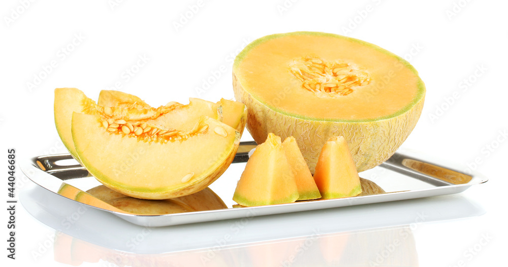 Cut melon on metal tray isolated on white