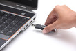 Person inserting a usb drive into a laptop