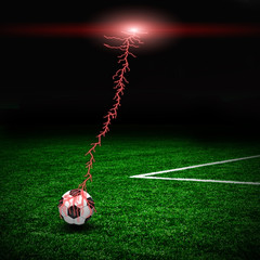 Soccer ball on the green field and lightning