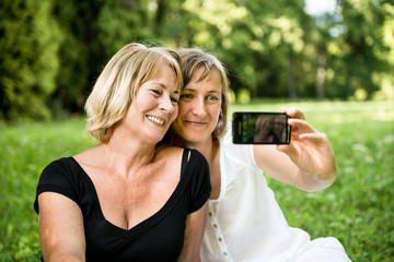 Wall Mural - Senior mother with child taking picture