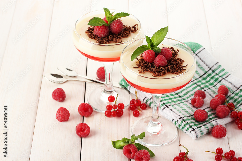 fruit jelly with berries in glasses on wooden table