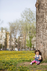 Canvas Print - Little girl by the tree