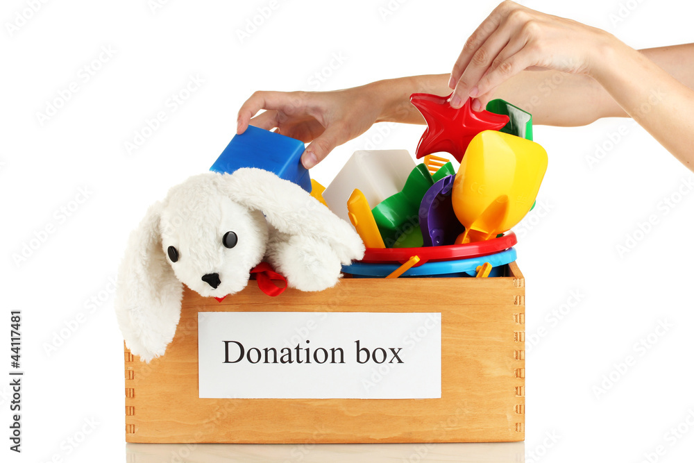 Donation box with children toys on white background close-up