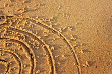 Drawing In The Sand On The Beach