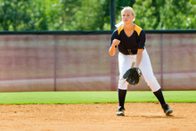 Young Teen Girl Playing Softball In Organized Game