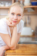 © listercz - Beautiful relaxed woman standing at the kitchen counter