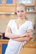© listercz - Beautiful relaxed woman standing at the kitchen counter