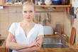 © listercz - Beautiful relaxed woman standing at the kitchen counter