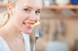 © listercz - Woman tasting cooked macaroni in the kitchen, mac and cheese
