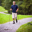 © lightpoet - active handsome senior man nordic walking outdoors