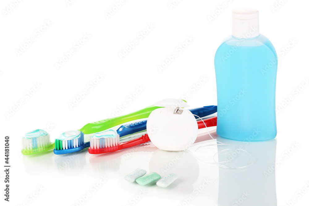 Toothbrush, chewing gum and dental floss isolated on white