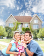 © grinny - Happy family near new house.