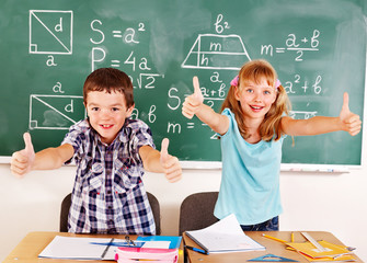 Sticker - School child sitting in classroom.