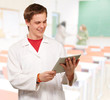 © Krakenimages.com - portrait of young academic holding a digital tablet at classroom