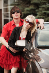 Young couple with a convertible car