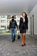 © M-Production - Bandit in mask following businesswoman. Robbery concept