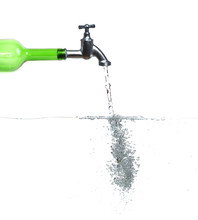 Faucet On Green Bottle With Water And Bubbles