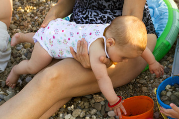 baby playing on the beach