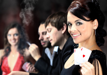 Poker players sitting around a table at a casino