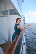 © Pavel Losevsky - young smiling woman traveling on ship and draws handrail