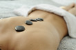 © javiindy - Attractive woman getting a stone massage in a spa