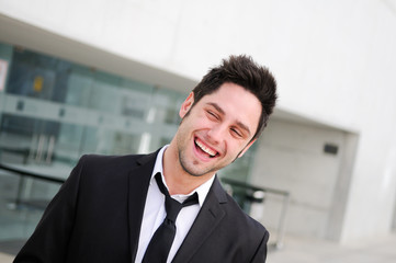 Portrait of a handsome young businessman laughing