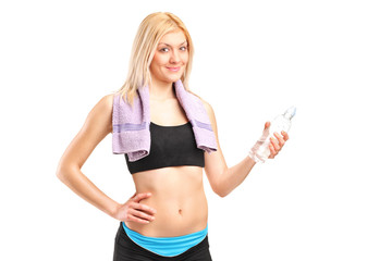 Poster - Attractive sportswoman with a bottle of water posing after train