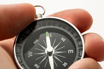 Wall Mural - Hand holding silver black compass