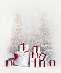 Christmas trees with heap of gift boxes over white background