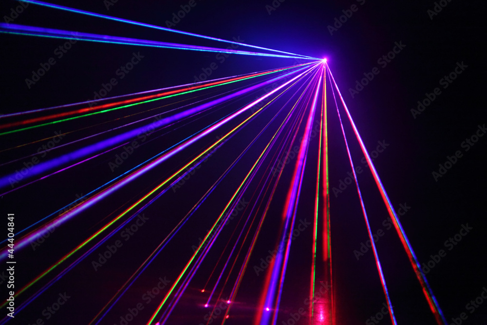 Lot of beautiful multi-colored laser beams in dark at disco. - obrazy, fototapety, plakaty 