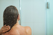 © Alliance - Woman bathing in shower under water jet. Rear view