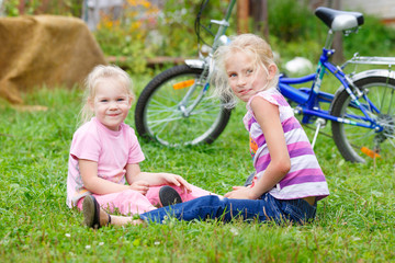 Two little girls playing in the meadow