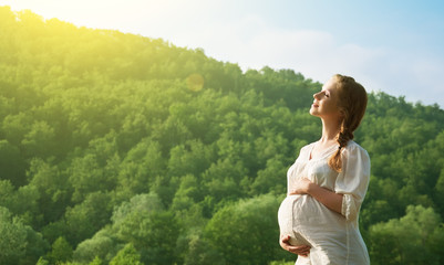 pregnant woman relaxing and enjoying life in nature