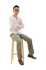 Canvas Print - Full body Asian man sitting on a chair