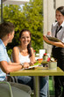 © CandyBox Images - Couple at cafe ordering from menu waitress