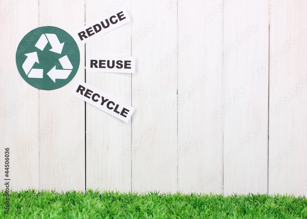 Recycling sign on wooden background